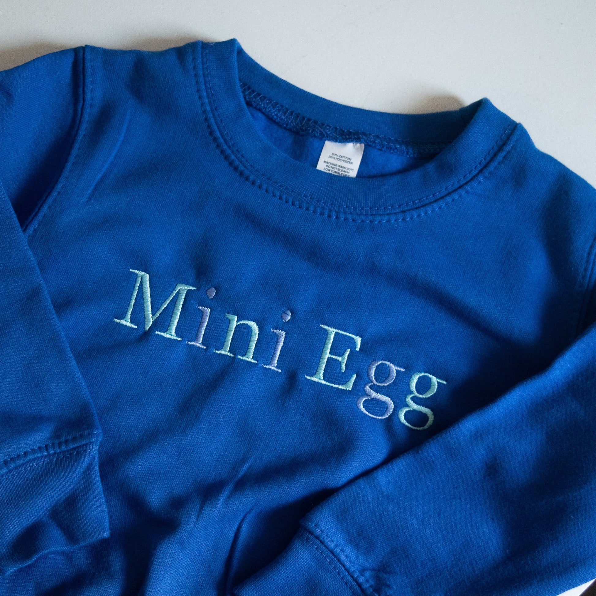 custom kids personalised jumper sweater in blue with blue mix of threads with name on it